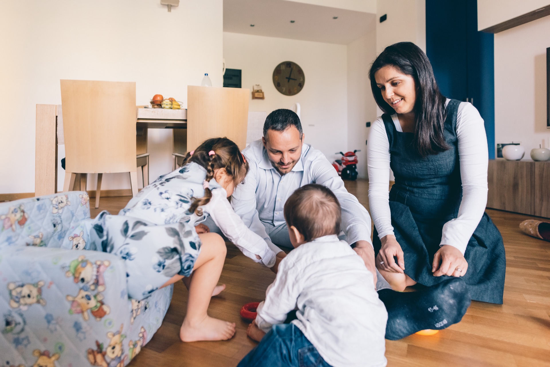 Happy mother playing with her family at home — simple natural skincare that fits a busy motherhood routine