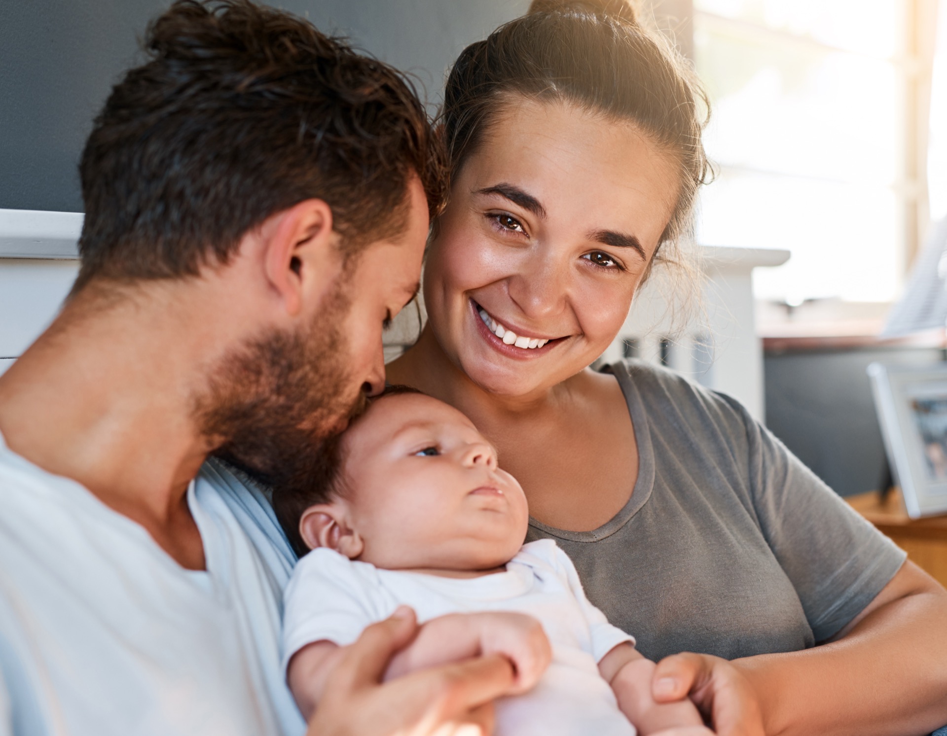 Family with their newborn at home — freezer meals for new moms are the most practical postpartum gift
